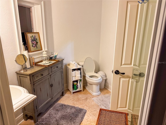 bathroom with tile patterned flooring and toilet