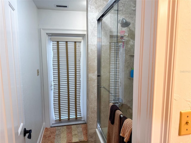 bathroom with a shower with shower door