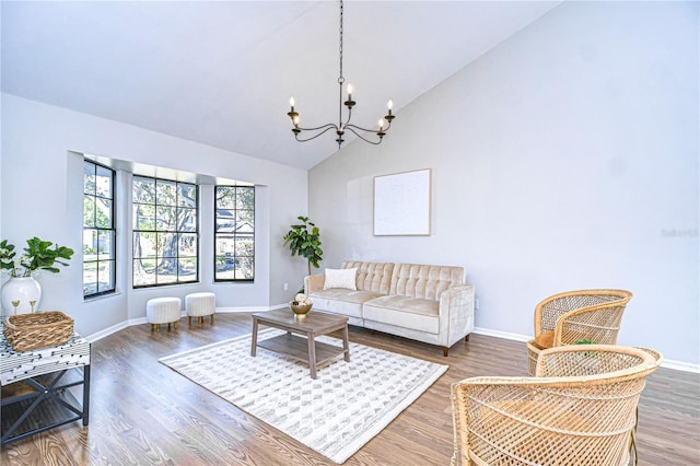 living room featuring dark hardwood / wood-style flooring, a chandelier, and vaulted ceiling