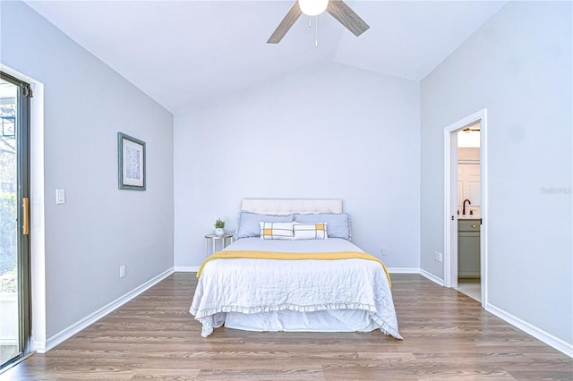 bedroom featuring lofted ceiling, ensuite bath, wood-type flooring, and ceiling fan