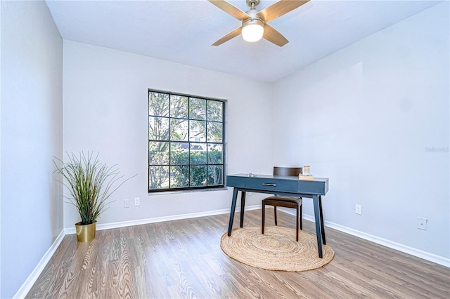 office with ceiling fan and dark hardwood / wood-style flooring