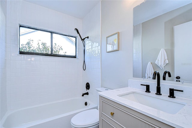 full bathroom with vanity, tiled shower / bath, and toilet