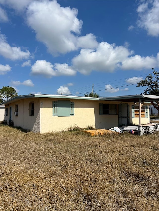 back of property featuring a lawn