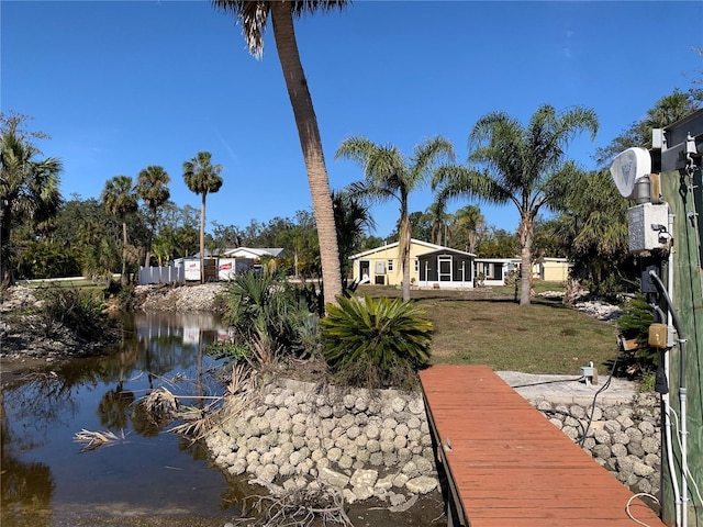 exterior space featuring a water view and a lawn