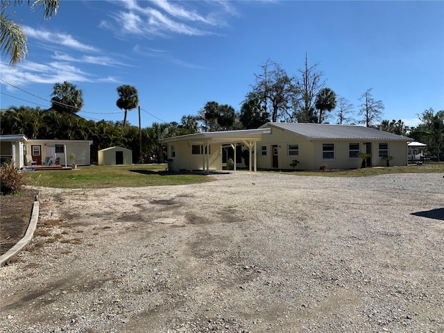 view of front of property with a front lawn and a storage unit