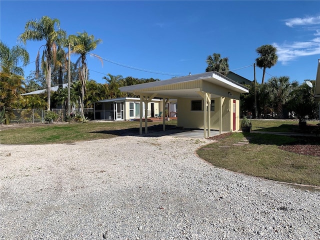 view of home's exterior with a carport and a yard