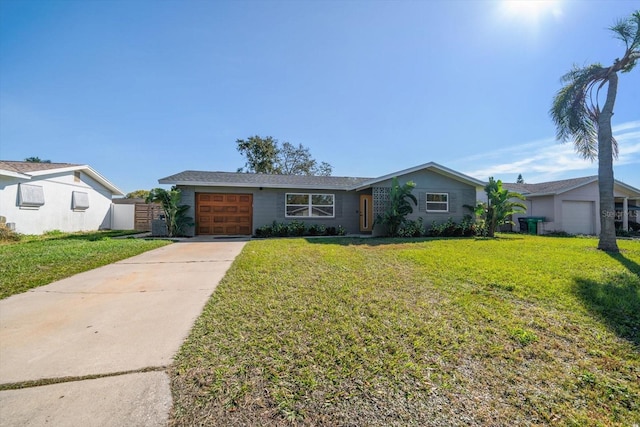 ranch-style home featuring a garage and a front lawn