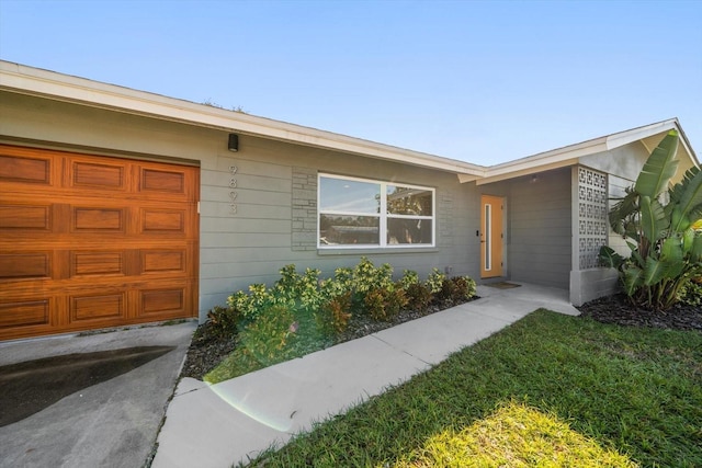 property entrance with a lawn