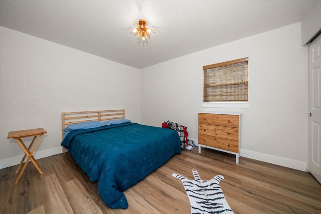 bedroom with wood-type flooring