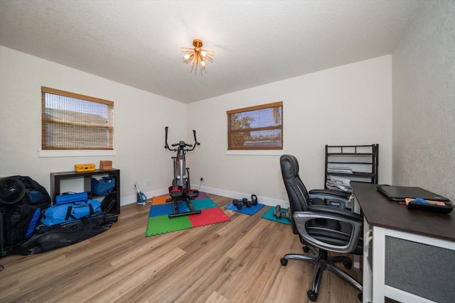 home office with hardwood / wood-style flooring, a textured ceiling, and a healthy amount of sunlight