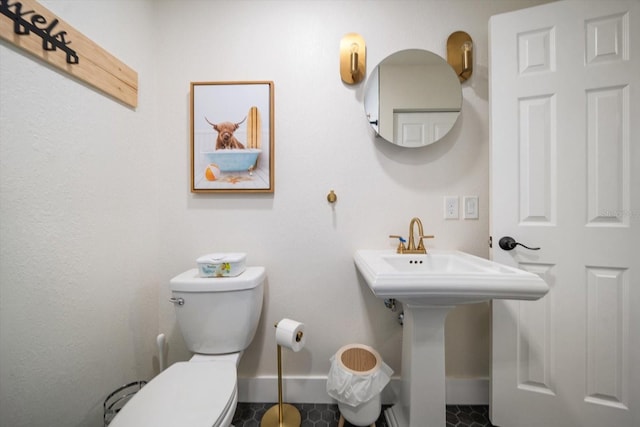 bathroom featuring toilet and tile patterned flooring