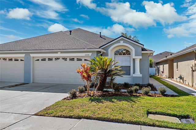 view of front of home featuring a garage and a front lawn