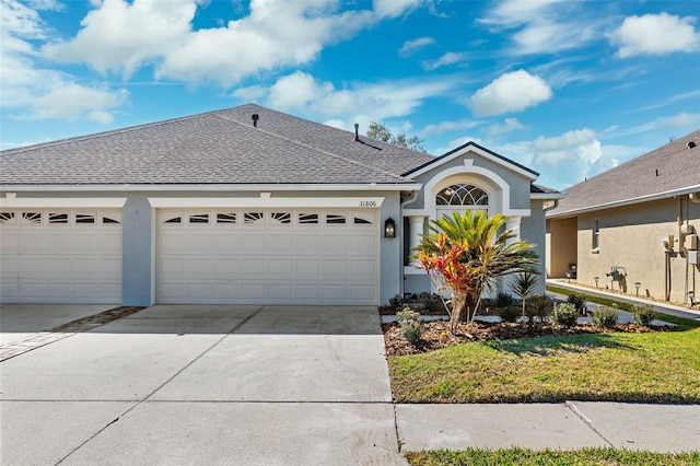 view of front facade featuring a garage and a front lawn