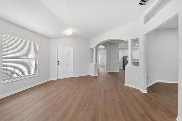 foyer featuring decorative columns and hardwood / wood-style floors