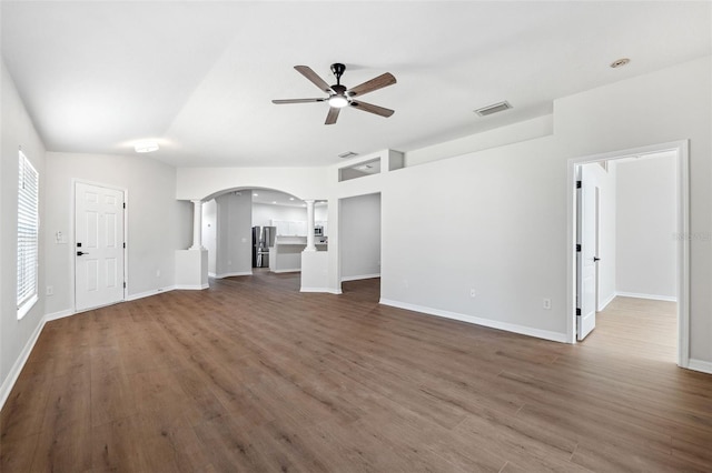 unfurnished living room featuring ceiling fan and dark hardwood / wood-style floors