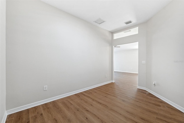 unfurnished room with wood-type flooring