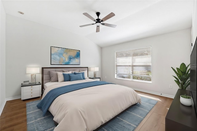 bedroom with dark wood-type flooring, ceiling fan, and vaulted ceiling