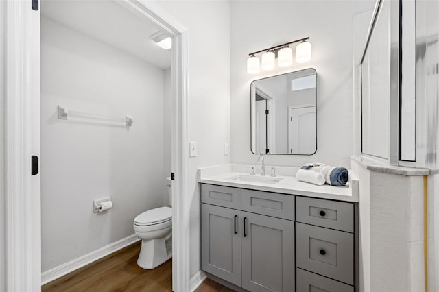 bathroom featuring vanity, toilet, and hardwood / wood-style floors