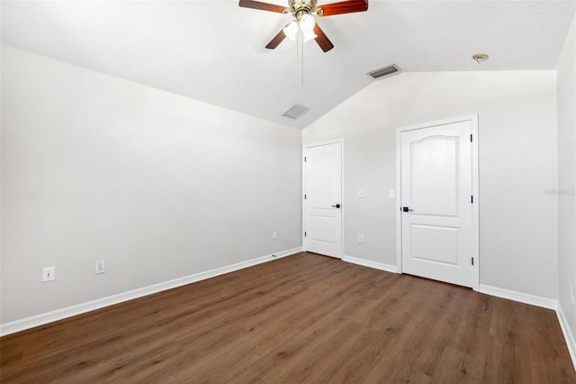 unfurnished bedroom featuring ceiling fan, lofted ceiling, and dark hardwood / wood-style flooring