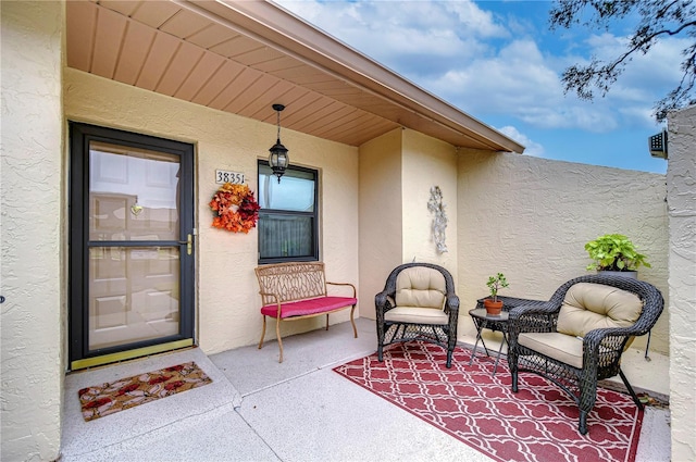 view of exterior entry with a patio