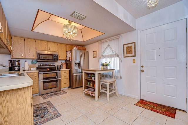 kitchen with stainless steel appliances, sink, light tile patterned floors, and a chandelier