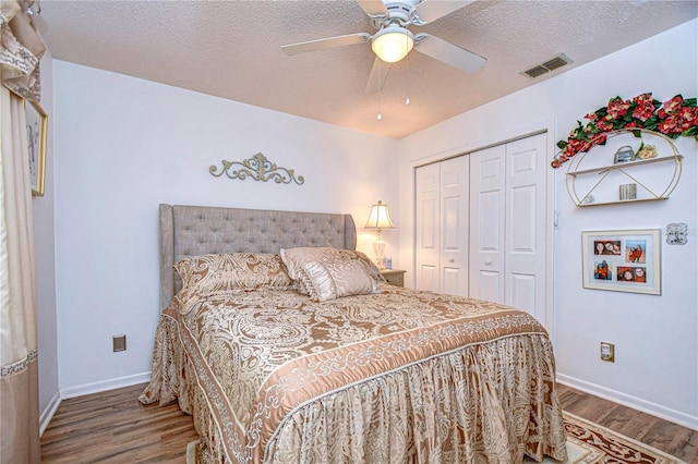 bedroom with hardwood / wood-style floors, a closet, and a textured ceiling