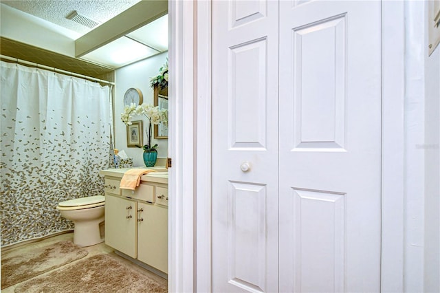 bathroom with vanity, a shower with curtain, and toilet