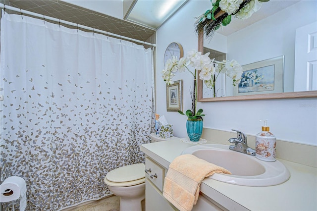 bathroom featuring vanity, toilet, and curtained shower