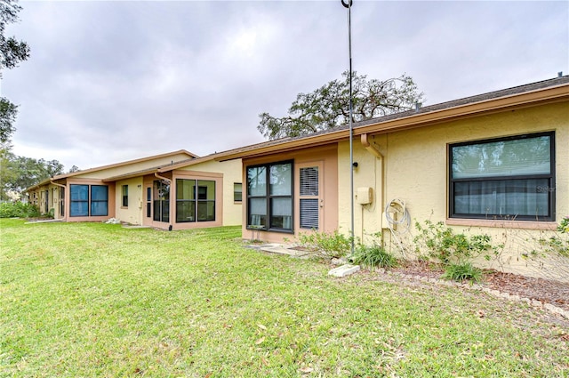 rear view of property with a lawn