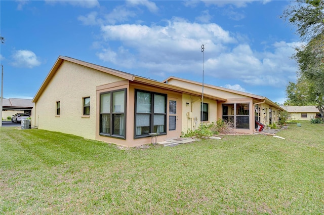 rear view of property featuring a yard