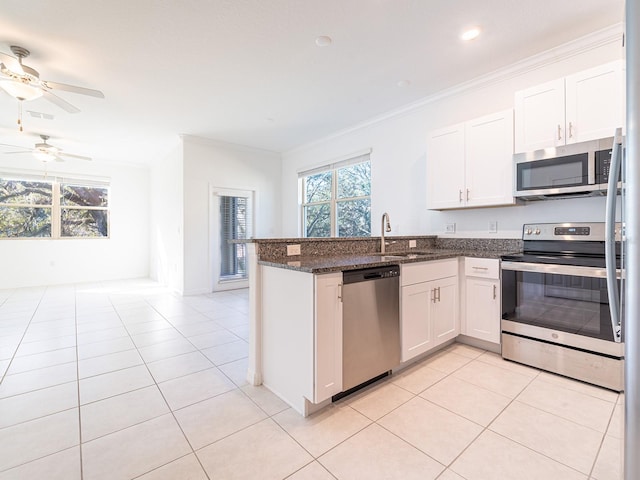 kitchen featuring white cabinetry, sink, stainless steel appliances, and kitchen peninsula