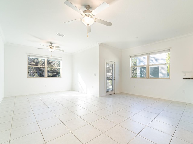 tiled empty room featuring ceiling fan and ornamental molding