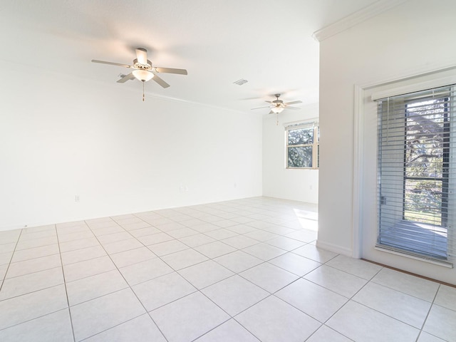 unfurnished room featuring crown molding, ceiling fan, and light tile patterned flooring