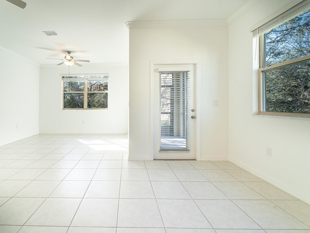 unfurnished room with crown molding, a healthy amount of sunlight, light tile patterned floors, and ceiling fan