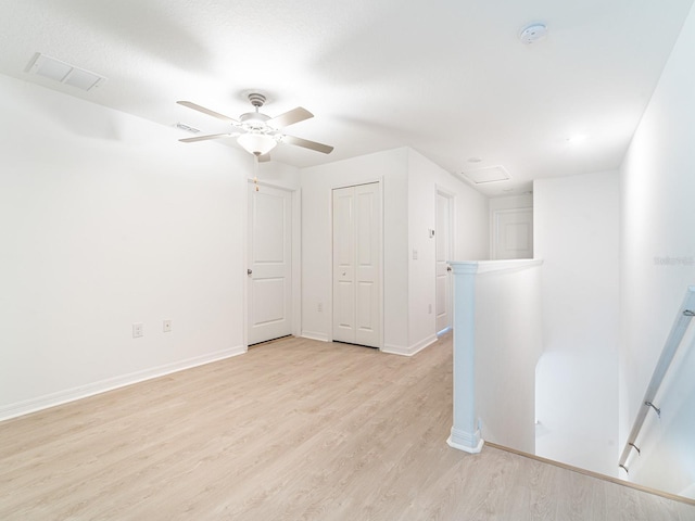 additional living space with ceiling fan and light wood-type flooring