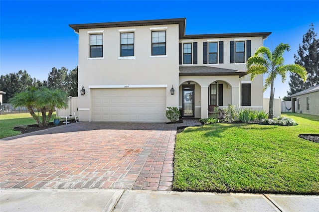 view of front of house featuring a garage and a front lawn