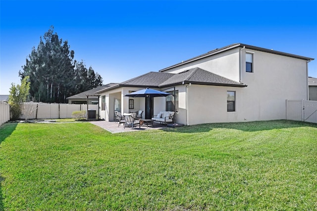 back of property featuring a lawn and a patio