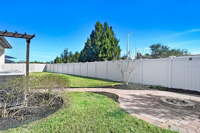 view of yard featuring central AC, an outdoor fire pit, and a patio area