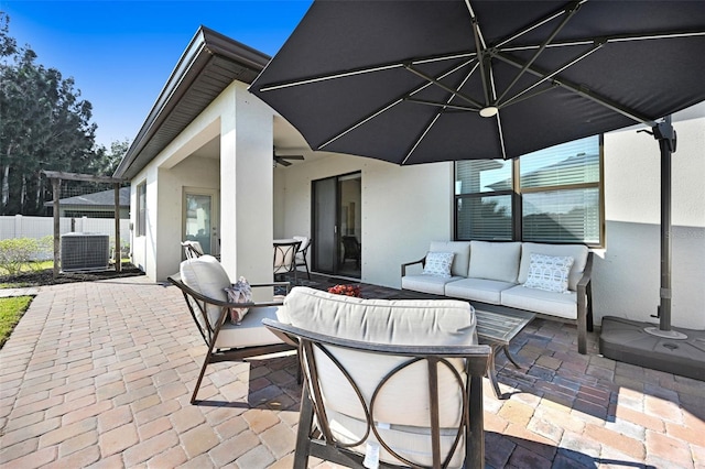 view of patio with cooling unit, outdoor lounge area, and ceiling fan