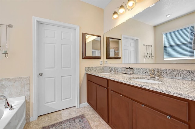 bathroom with tile patterned floors, vanity, and a washtub