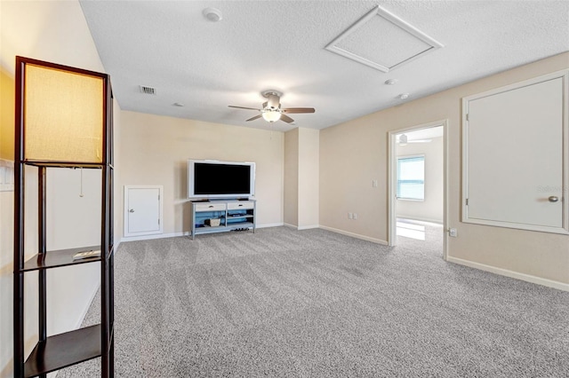 unfurnished living room with ceiling fan, light carpet, and a textured ceiling