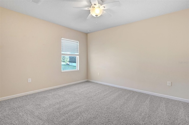 carpeted spare room with ceiling fan and a textured ceiling