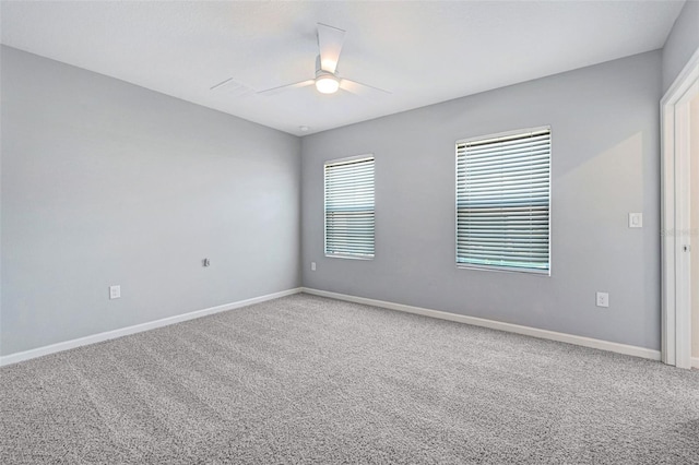 spare room with ceiling fan and carpet flooring