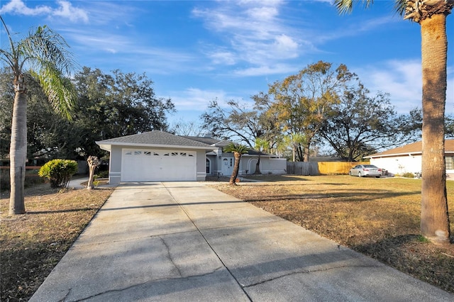 ranch-style house with a garage and a front lawn