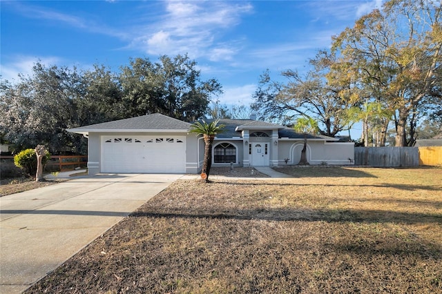 ranch-style home featuring a garage and a front yard