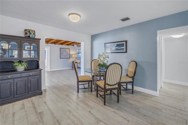 dining space with light hardwood / wood-style floors and ceiling fan