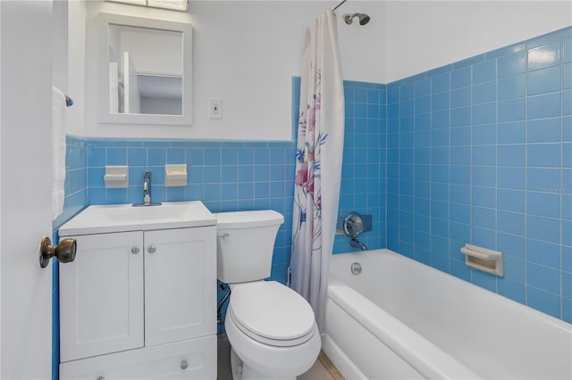 full bathroom with shower / bath combo, tile walls, vanity, and toilet