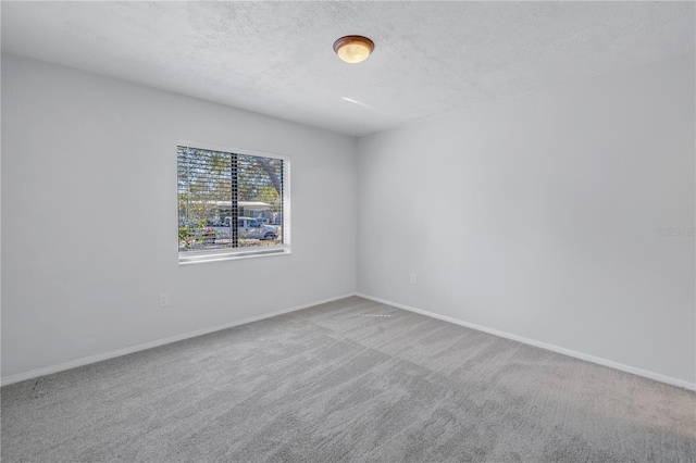 empty room featuring carpet floors and a textured ceiling