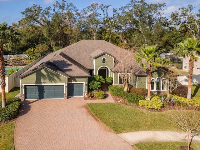 view of front of property featuring a garage and a front yard