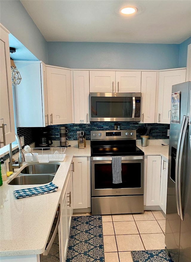 kitchen featuring white cabinetry, stainless steel appliances, sink, and tasteful backsplash